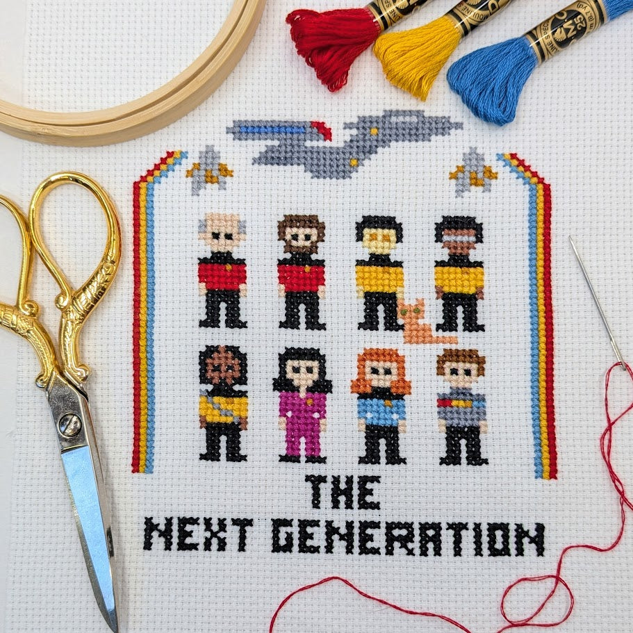 Cross-stitch pattern of characters from science fiction series with embroidery tools on a white background