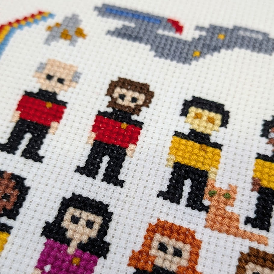 Cross-stitched pattern of characters from a science fiction series on a white background