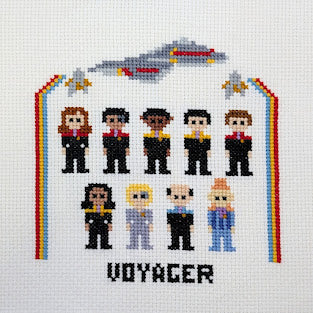 Cross-stitch image of a group of people in front of a spaceship with 'Voyager' text on a white background.