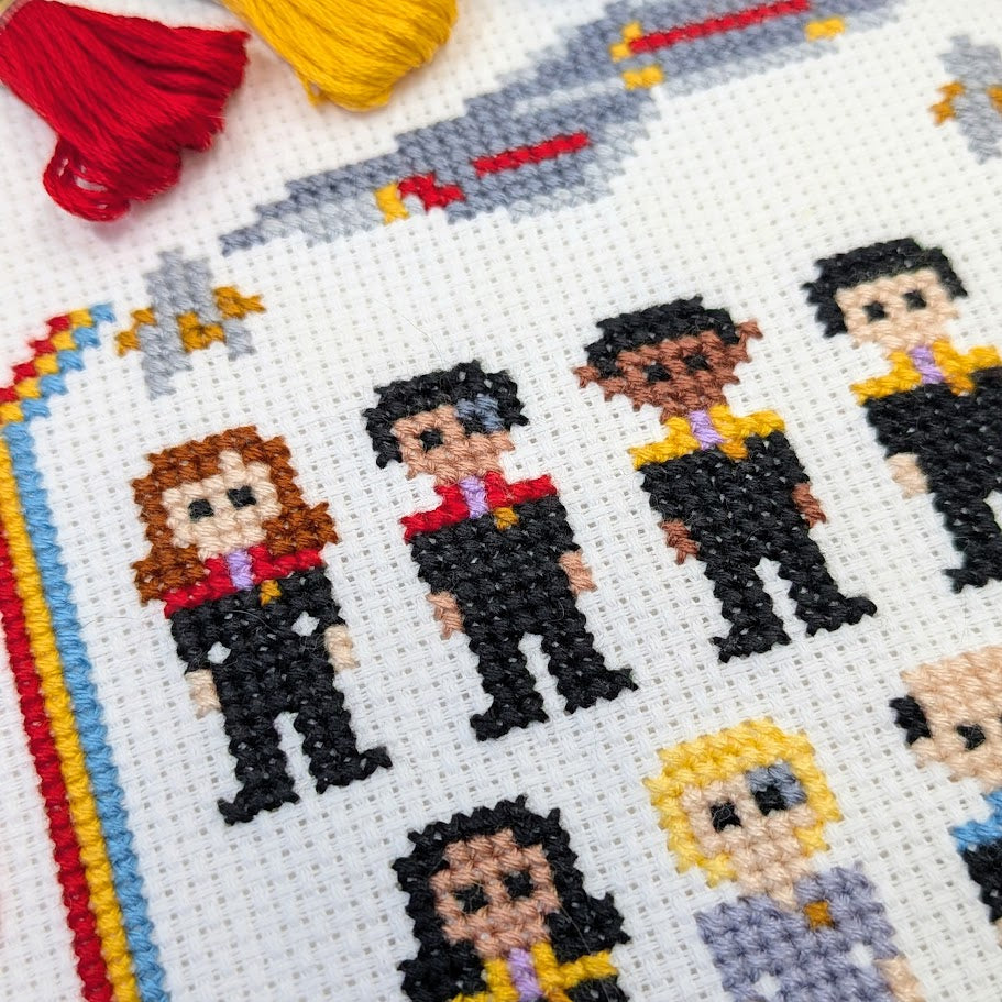 Cross-stitched characters in various poses with colorful thread on a white fabric background.