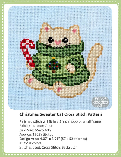 Cross stitch pattern cover for "Christmas Sweater Cat", showing a completed stitched design of a cream-colored cat wearing a green sweater and holding a red-and-white candy cane on a light blue fabric, with text below detailing the pattern specifications.